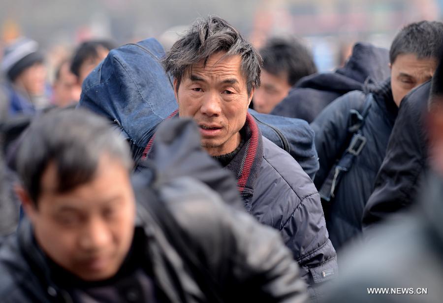 Migrant worker Liu Jianzhong, who is heading to southwest China's Sichuan Province as a kilnman, enters Zhengzhou Railway Station in Zhengzhou, capital of central China's Henan Province, Feb. 15, 2013. China's railways will be tested Friday, when passenger flows peak at the end of the Spring Festival holiday. Some 7.41 million trips will be made on the country's railways with travelers returning to work as the week-long Lunar New Year celebration draws to a close, the Ministry of Railways said. (Xinhua/Zhao Peng)   