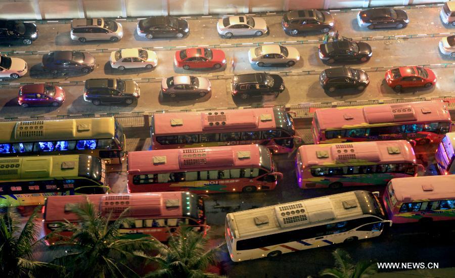 Vehicles which were detained by a heavy fog wait to leave a port in Haikou, capital of south China's Hainan Province, late Feb. 15, 2013. A total of 46,000 passengers and 8,700 vehicles have left the Port of Haikou from 8:00 p.m. Friday to 8:00 a.m. Saturday, after being detained by a heavy fog that disrupted the waterway traffic across the Qiongzhou Strait. (Photo/ Xinhua) 