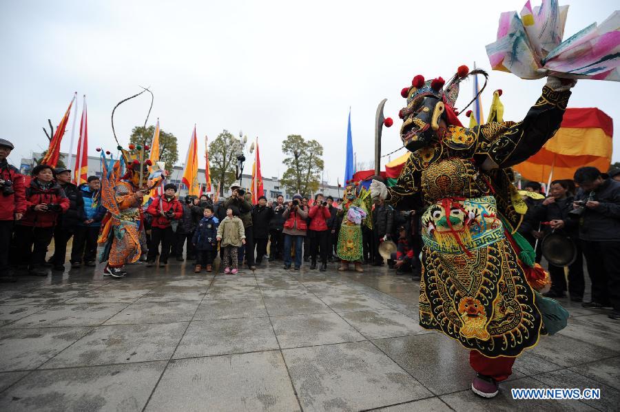 Performers perform Nuo dance, a kind of exorcising dance, during the 14th Folk Culture Festival in Liyang City, east China's Jiangsu Province, Feb. 17, 2013. (Xinhua/Han Yuqing)