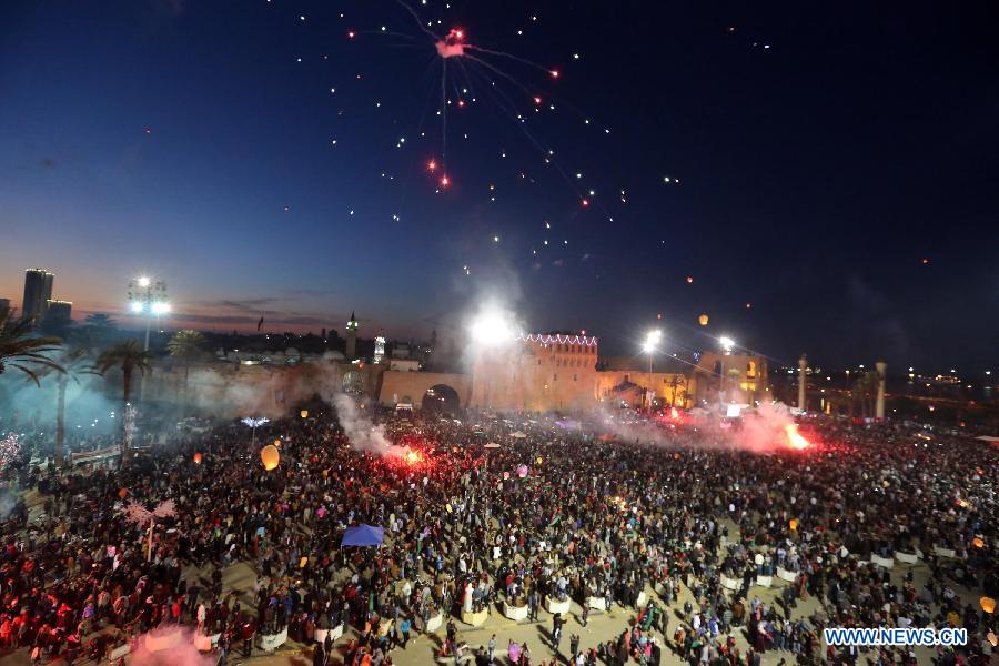 People gather to enjoy the fireworks during a celebration for the second anniversary of the Libyan uprising at the Martyrs' Square in Tripoli on Feb. 17, 2013. (Xinhua/Hamza Turkia) 