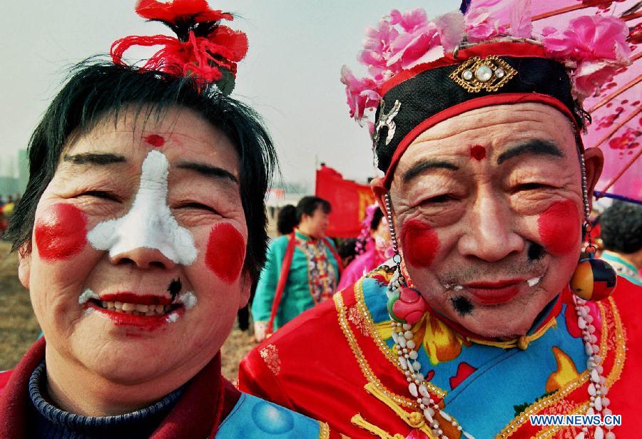 File photo taken on Feb. 13, 2002 shows two Shehuo performers at a temple fair in Zhengzhou, capital of central China's Henan Province. (Xinhua/Wang Song)