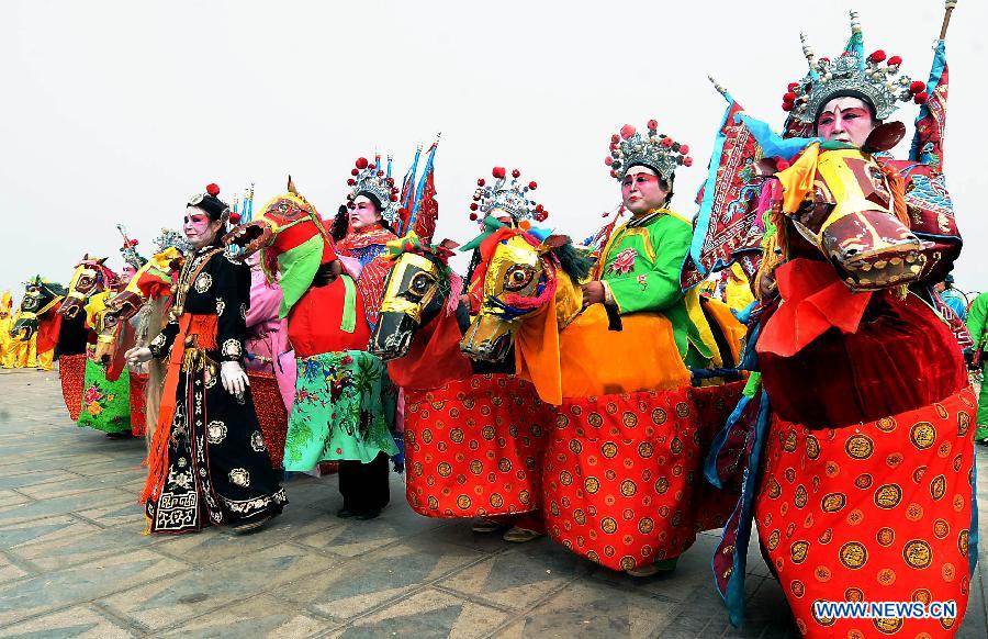 File photo taken on March 18, 2010 shows members of a Shehuo performance team preparing for shows at a temple fair in Huaiyang, central China's Henan Province. (Xinhua/Wang Song)