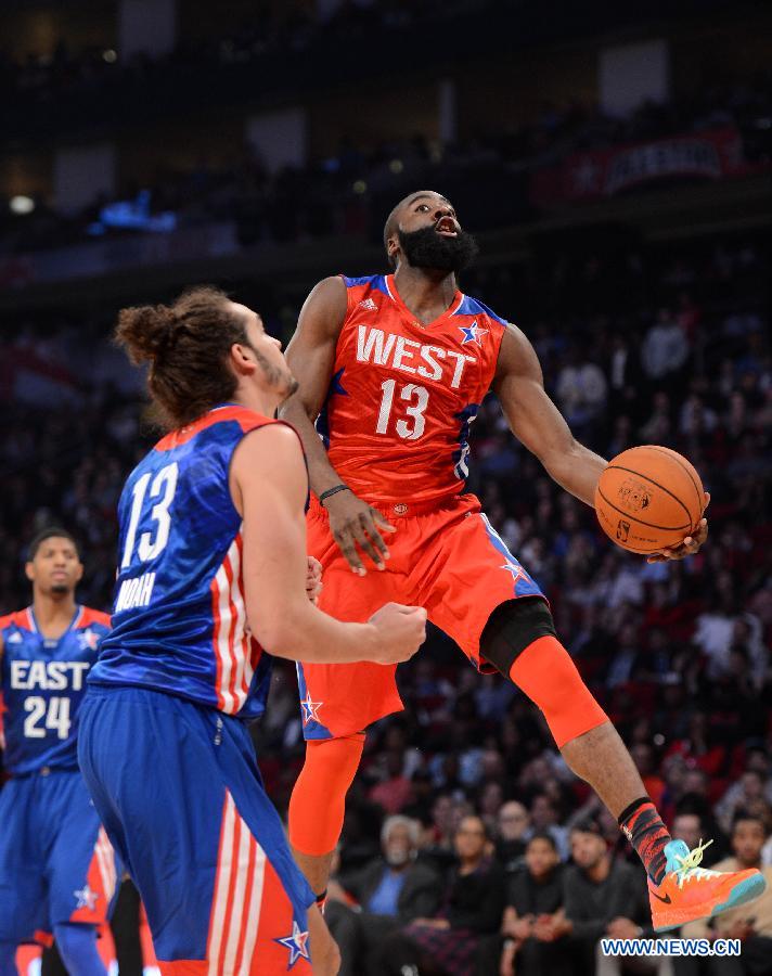 James Harden (top) of the Houston Rockets and the Western Conference goes up for a shot during the 2013 NBA All-Star game at the Toyota Center in Houston, the United States, Feb. 17, 2013. (Xinhua/Yang Lei) 