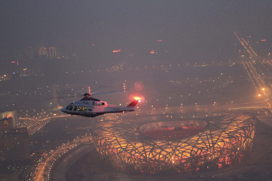 A police helicopter patrols over Beijing on Feb. 9, 2013. Beijing police dispatched five helicopters to ensure the capital's security on the eve of the Lunar New Year. (Xinhua/Zhang Yan)