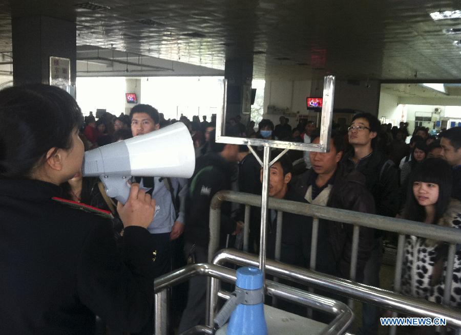 A staff member of Heyuan Railway Station announces the latest train information through a speaker at Heyuan Railway Station in Heyuan City, south China's Guangdong Province, Feb. 22, 2013. A 4.8-magnitude quake jolted Heyuan City in Guangdong Province at 11:34 a.m. Friday (Beijing Time), according to the China Earthquake Networks Center. The epicenter, with a depth of 11 km, was monitored at 23.9 degrees north latitude and 114.5 degrees east longitude, the center said. Affected by the earthquake, most trains here were delayed and many passengers were detained at the railway station. (Xinhua/Tan Xingfu) 