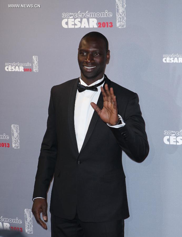 French actor Omar Sy arrives at the 38th annual Cesar awards ceremony held at the Chatelet Theatre in Paris, Feb. 22, 2013. (Xinhua/Gao Jing) 