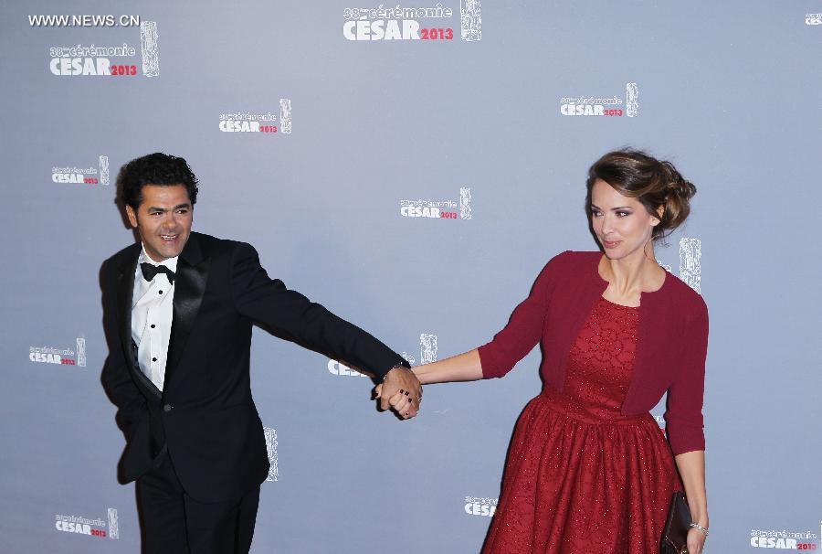 French actor Jamel Debbouze (L) and his wife, French journalist Melissa Theuriau (R) arrive at the 38th annual Cesar awards ceremony held at the Chatelet Theatre in Paris, France, Feb. 22, 2013. (Xinhua/Gao Jing) 