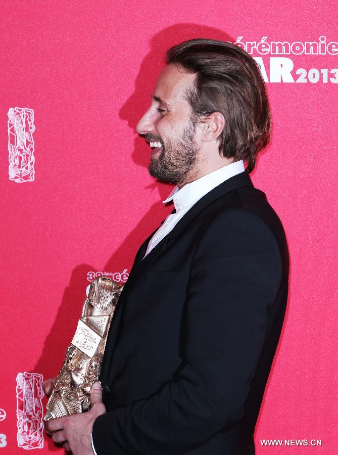Belgian actor Matthias Schoenaerts holds his Best Most Promising Actor award for his role in 'De Rouille et d'Os' as he poses for photos during the 38th annual Cesar awards ceremony held at the Chatelet Theatre in Paris, France, Feb. 22, 2013. (Xinhua/Gao Jing)