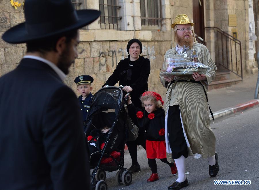 An Ultra-Othordox Jewish family dressed in disguises go to visit relatives during Purim festival, a Jewish colorful and popular holiday, in Jerusalem, on Feb. 25, 2013. In Jerusalem, Purim was celebrated from sunset on Sunday, Feb. 24, until sunset on Monday, Feb. 25, one day later than it is in the rest of the world. (Xinhua/Yin Dongxun) 