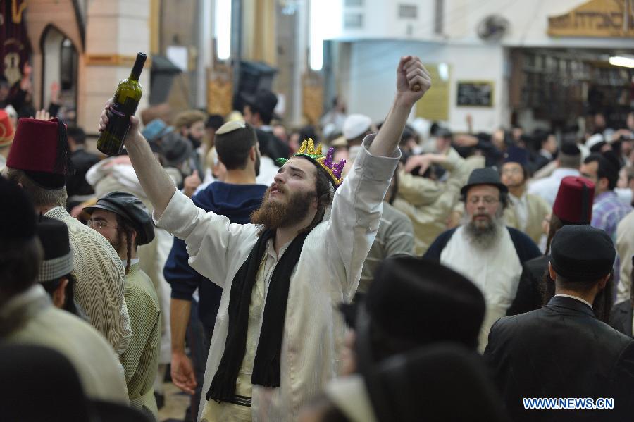 Ultra-Othordox Jews dance in a synagogue to celebrate Purim festival, a Jewish colorful and popular holiday, in Jerusalem, on Feb. 25, 2013. In Jerusalem, Purim was celebrated from sunset on Sunday, Feb. 24, until sunset on Monday, Feb. 25, one day later than it is in the rest of the world. (Xinhua/Yin Dongxun) 