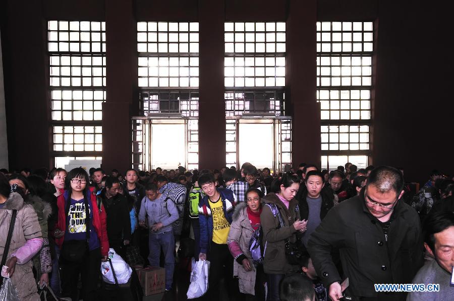 Passengers walk out of the railway station in Lhasa, capital of southwest China's Tibet Autonomous Region, Feb. 26, 2013. Lhasa rail station saw a daily of some 3,700 arrivals as migrant workers returned Lhasa to work after the annual Spring Festival holidays. (Xinhua/Liu Kun) 