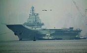 China's aircraft carrier anchors in military port 
