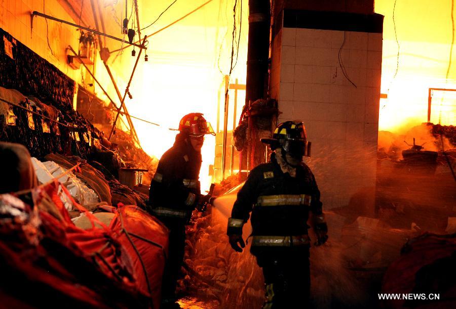 Members of Fire Department work to extinguish a fire in the Merced's Market, in Mexico City, capital of Mexico, on Feb. 27, 2013. The fire that broke out this morning in the Merced's Market was already controlled by the Fire Department with no victims being registered, official sources said. (Xinhua/Angel Vargas) 