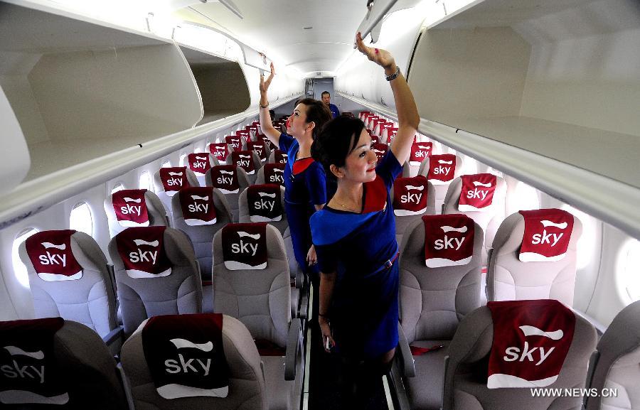 Two airline stewardesses check the cabin of a Russian-made commercial plane Sukhoi Super Jet 100 (SSJ 100) at Halim Perdana Kusuma Airport in Jakarta, Indonesia, Feb. 28, 2013. An Indonesian airlines firm, Sky Aviation, received on Wednesday the initial delivery of SSJ 100, expecting five to join the fleet by the end of this year. (Xinhua/Agung Kuncahya B.) 