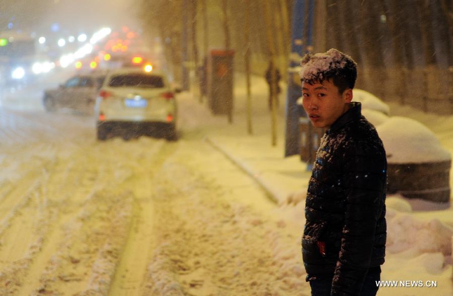 A man looks on in snow in Changchun, capitalf of northeast China's Jilin Province, Feb. 28, 2013. Temperature in north China is forecasted to drop six to 12 degrees celcius due to a coming cold front while heavy snowfall may likely to hit the northeast provinces, accoding to China's National Meteorological Centre on Thursday. (Xinhua/Xu Chang)