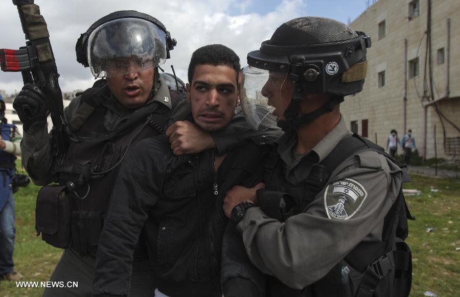 Israeli soldiers arrest a Palestinian protester outside Ofer Prison near Ramallah on Feb. 28, 2013, following a protest supporting Palestinian prisoners. Israeli troops arrested 3 protesters and 19 were reportedly injured. (Xinhua/Fadi Arouri)