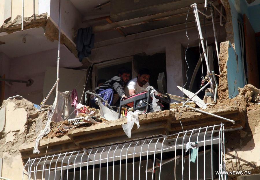 Pakistani people examine their damaged home at the bomb blast site in southern Pakistani port city of Karachi, March 4, 2013. At least 45 people were killed and 150 others injured when twin blasts hit a residential area in Pakistan's southern port city of Karachi on Sunday night. (Xinhua/Arshad) 