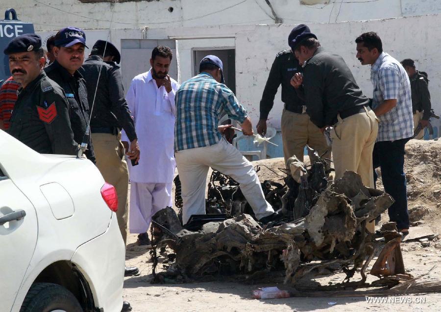 Pakistani security officials examine the wreckage of a vehicle at the bomb blast site in southern Pakistani port city of Karachi, March 4, 2013. At least 45 people were killed and 150 others injured when twin blasts hit a residential area in Pakistan's southern port city of Karachi on Sunday night. (Xinhua/Arshad) 