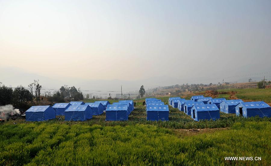Photo taken on March 4, 2013 shows the relief tents at Qiandian Village of Liantie Township in Eryuan County of Dali Bai Autonomous Prefecture, southwest China's Yunnan Province. A 5.5-magnitude earthquake hit Eryuan County on March 3. Thirty people have been confirmed injured, while some 21,000 people have been evacuated. (Xinhua/Lin Yiguang) 