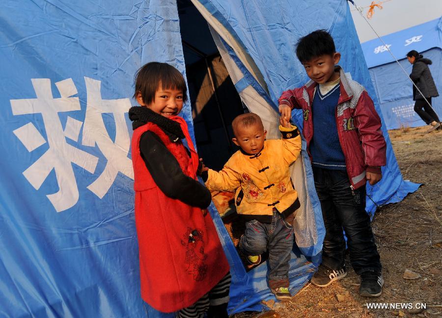 Children play in front of a relief tent at Qiandian Village of Liantie Township in Eryuan County of Dali Bai Autonomous Prefecture, southwest China's Yunnan Province, March 4, 2013. A 5.5-magnitude earthquake hit Eryuan County on March 3. Thirty people have been confirmed injured, while some 21,000 people have been evacuated. (Xinhua/Lin Yiguang) 