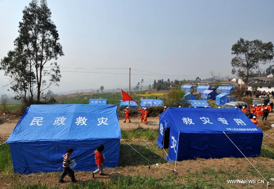 Photo taken on March 4, 2013 shows the relief tents at Qiandian Village of Liantie Township in Eryuan County of Dali Bai Autonomous Prefecture, southwest China's Yunnan Province. A 5.5-magnitude earthquake hit Eryuan County on March 3. Thirty people have been confirmed injured, while some 21,000 people have been evacuated. (Xinhua/Lin Yiguang) 