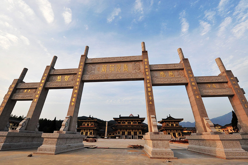 Memorial archways are seen in a complex that features a 48-meter-high bronze statue of Amitabha Buddha in Xingzi County, Jiangxi Province, March 3, 2013. The gilding work of the statue is completed on Sunday. The Buddha statue has been recognized as the highest Amitabha Buddha in the world and the only outdoor Amitabha Buddha in China. A total of 48-kilogram gold has been used to gild the Statue. The overall style of the Amitabha Buddha imitates the Buddha statues in the Longmen Grottoes and it can be regarded as a fine religious art with the highest level in the modem society, according to the principal of the project. (CNS/Hu Guolin)
