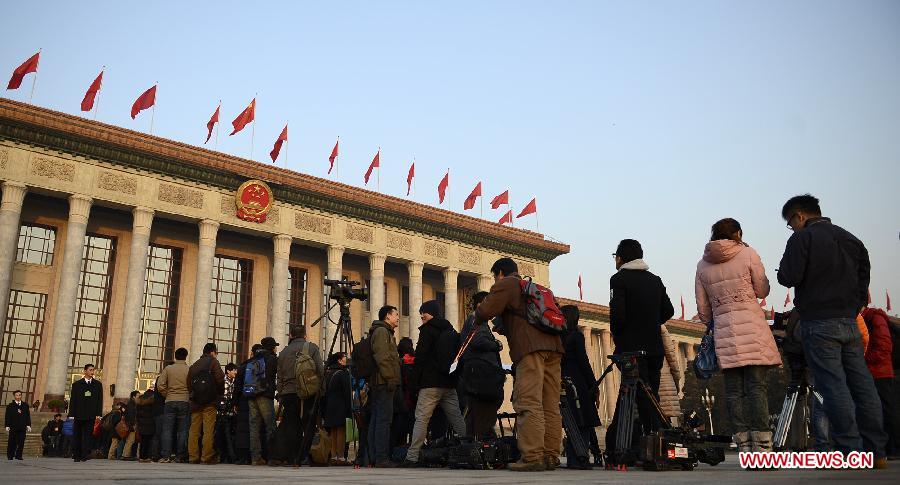 Journalists wait to enter into the Great Hall of the People in Beijing, capital of China, March 5, 2013. The first session of the 12th National People's Congress (NPC) will open here on March 5. (Xinhua/Wang Peng)