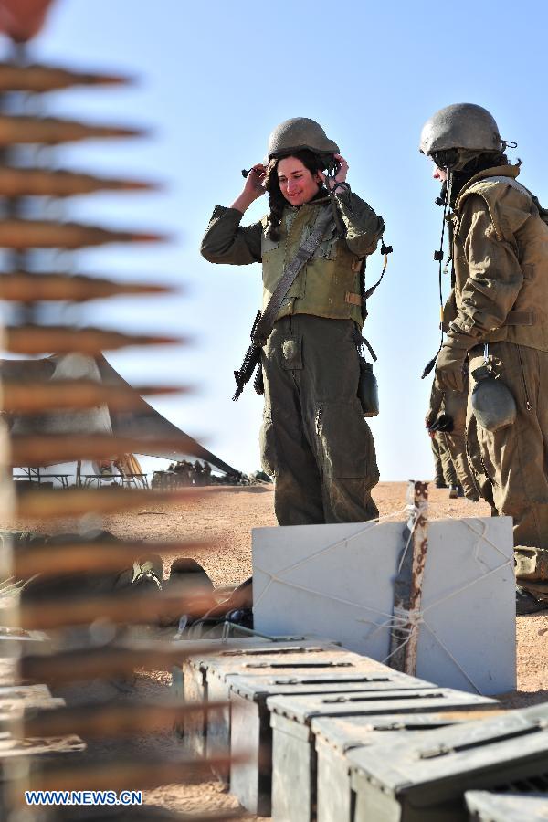 Female soldiers of Israel Defense Forces (IDF)'s Shiryon (tank corps) unit take part in a shooting training at Shizafon Armor Corps Training Base, south Israel, March 7, 2013. These female soldiers will become instructors in Shiryon unit after finishing their 4-month training. (Xinhua/ Yin Dongxun) 