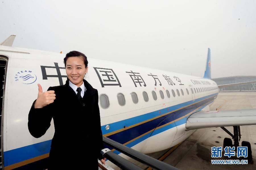 Li makes the gesture for smooth flight at the airplane gate on March 7, 2013.  Li Ying, born in 1986, was formally transferred to the North Branch of Southern Airline in June 2011 as copilot in the Airbus A320 fleet. She piloted the airplane from Shenyang to Shenzhen as a captain for the first time on March 8, 2013. (Photo/Xinhua)