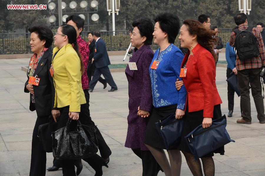 Female deputies to the 12th National People's Congress (NPC) walk to the Great Hall of the People in Beijing, capital of China, March 8, 2013. Women's presence in China's politics has been increasing in recent decades. The number of female deputies to the 12th National People's Congress and members of the 12th National Committee of the Chinese People's Political Consultative Conference (CPPCC) rise to 699 and 399, reaching 23.4% and 18.4% of the total respectively. (Xinhua/Wang Jianhua) 