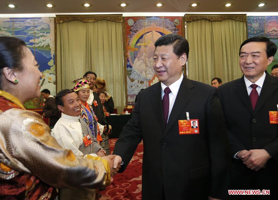 Xi Jinping (2nd R), general secretary of the Central Committee of the Communist Party of China (CPC), talks with a deputy to the 12th National People's Congress (NPC) from southwest China's Tibet Autonomous Region, in Beijing, capital of China, March 9, 2013. Xi joined a discussion with the Tibet delegation attending the first session of the 12th NPC in Beijing on Saturday. (Xinhua/Ju Peng)