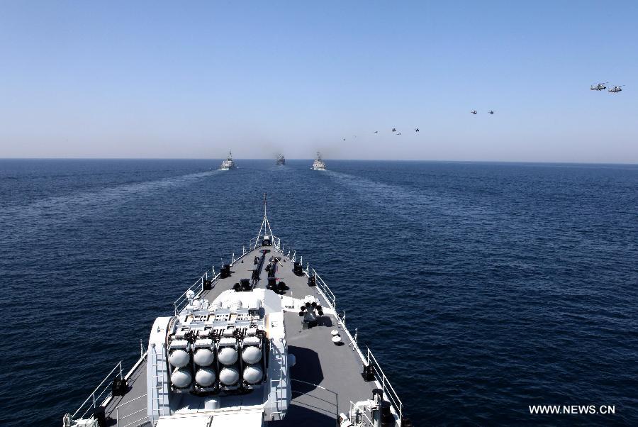 Helicopters fly over a naval ship during the AMAN-13 exercise in the Arabian Sea, March 8, 2013. Naval ships from 14 countries, including China, the United States, Britain and Pakistan, joined a five-day naval drill in the Arabian Sea from March 4, involving 24 ships, 25 helicopters, and special forces. (Xinhua/Rao Rao)