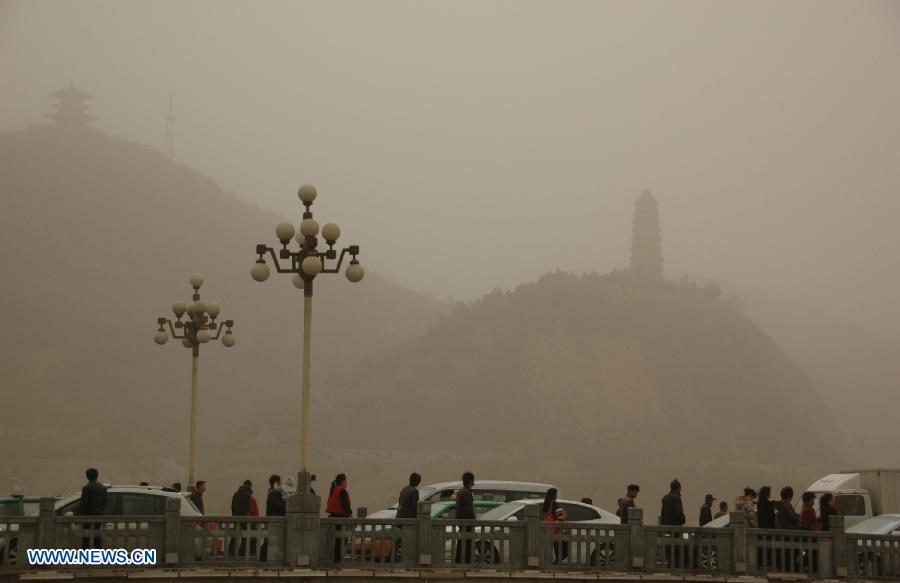 Sand and dust shroud the city of Yan'an, north China's Shaanxi Province, March 9, 2013. A cold front brought strong wind as well as sand and dust to most part of north China region on March 9. (Xinhua/He Huaqiao) 
