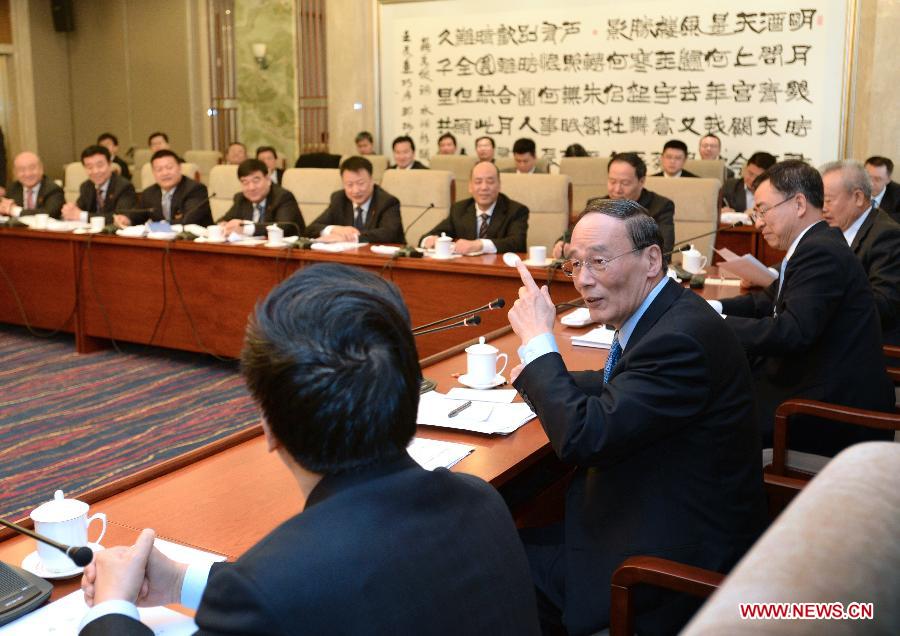 Wang Qishan, a member of the Standing Committee of the Political Bureau of the Communist Party of China (CPC) Central Committee, joins a discussion with deputies from northwest China's Ningxia Hui Autonomous Region, who attend the first session of the 12th National People's Congress (NPC), in Beijing, capital of China, March 11, 2013. (Xinhua/Ma Zhancheng)