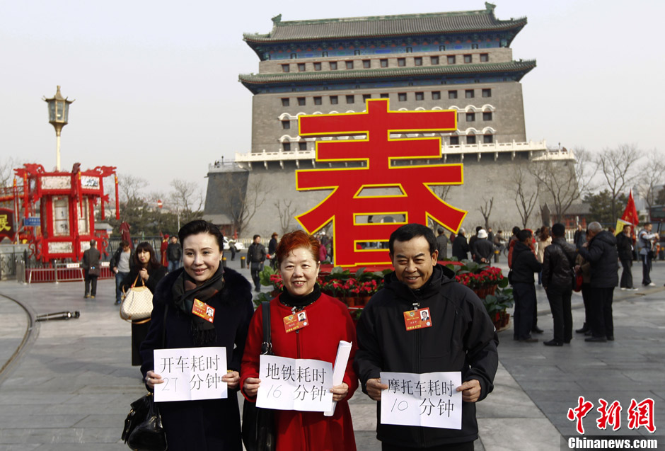 Members of CPPCC National Committee Zhao Xiujun, Gao Peifen, Zuo Zongshen (from left to right) show their time used for travelling from Xuanwumen to Qianmen on March 11, 2013. (CNS/Liu Guanguan) 