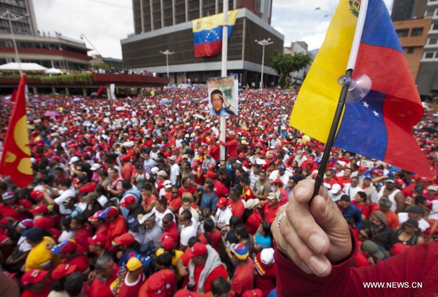 Supporters take part in a rally held after Venezuela's acting President Nicolas Maduro's official registration as candidate for presidential elections of April 14, outside the headquarters of the National Electoral Council of Venezuela in Caracas, capital of Venezuela, on March 11, 2013. (Xinhua/David de la Paz) 