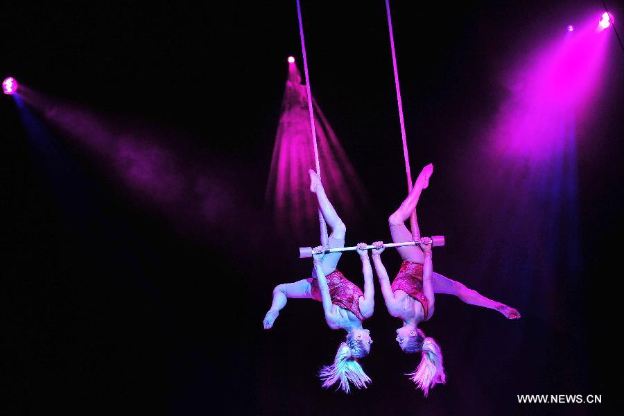 Acrobats perform during the media preview of the circus show "Le Noir" held in the Marina Bay Sands Theatre in Singapore, March 12, 2013. The show with the theme of "Black, white and red" premieres in Singapore Tuesday. (Xinhua/Then Chih Wey) 
