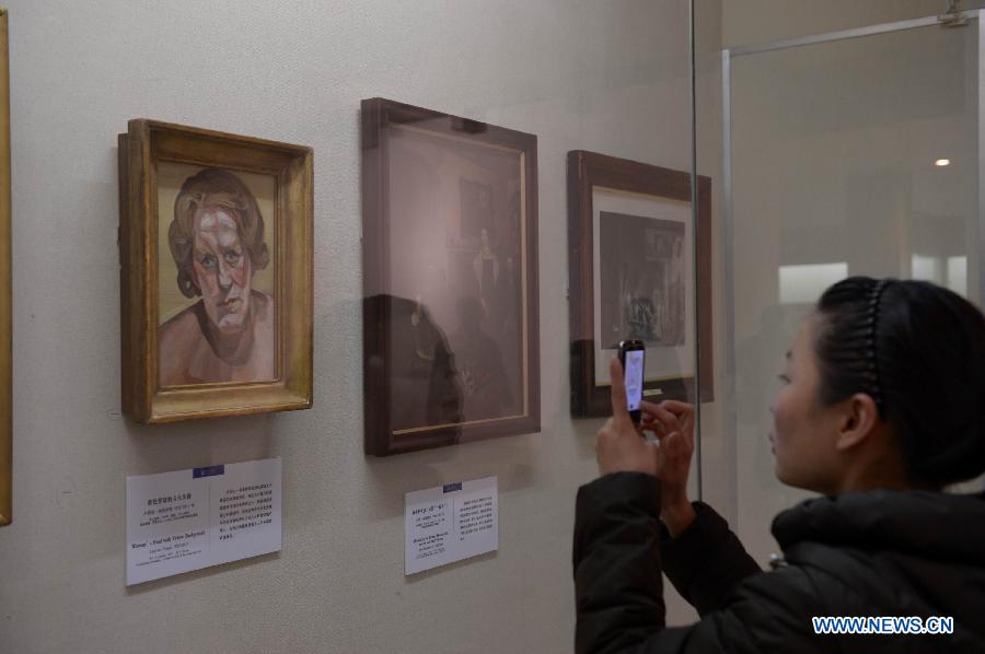 A visitor takes a picture of an art work at an exhibition showing British artworks in Nanchang, capital of east China's Jiangxi Province, March 14, 2013. An exhibition displaying 80 British art works kicked off here on Thursday. (Xinhua/Zhou Mi) 