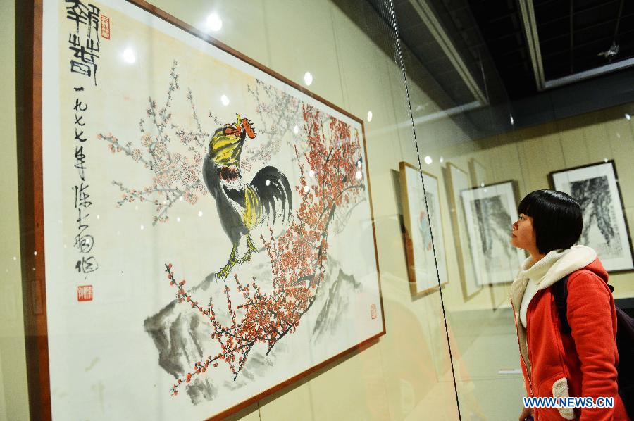 A visitor views a work of inkwash painter Chen Dayu (1912-2001) during the exhibition "No End for Art" at the Zhejiang Art Museum in Hangzhou, capital of east China's Zhejiang Province, March 14, 2013. Some 140 pieces of Chen Dayu's inkwash paintings created between 1945 and 2001 were shown at the exhibition, which was inaugurated Thursday in Hangzhou. Chen was a student of Qi Baishi, another inkwash painting master, and specialised in drawing flowers and birds. (Xinhua/Long Wei) 
