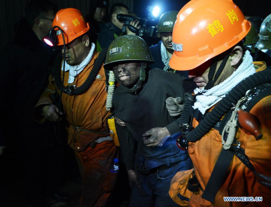A rescued miner is helped to get to the surface after a rock outburst took place at the Junde Coal Mine in Hegang City, northeast China's Heilongjiang Province, March 15, 2013. Sixteen miners had been rescued and four others remained trapped underground in the coal mine accident which occurred early Friday. The coal mine is owned by the state-owned Heilongjiang Longmay Mining Holding Group. (Xinhua/Wang Kai) 