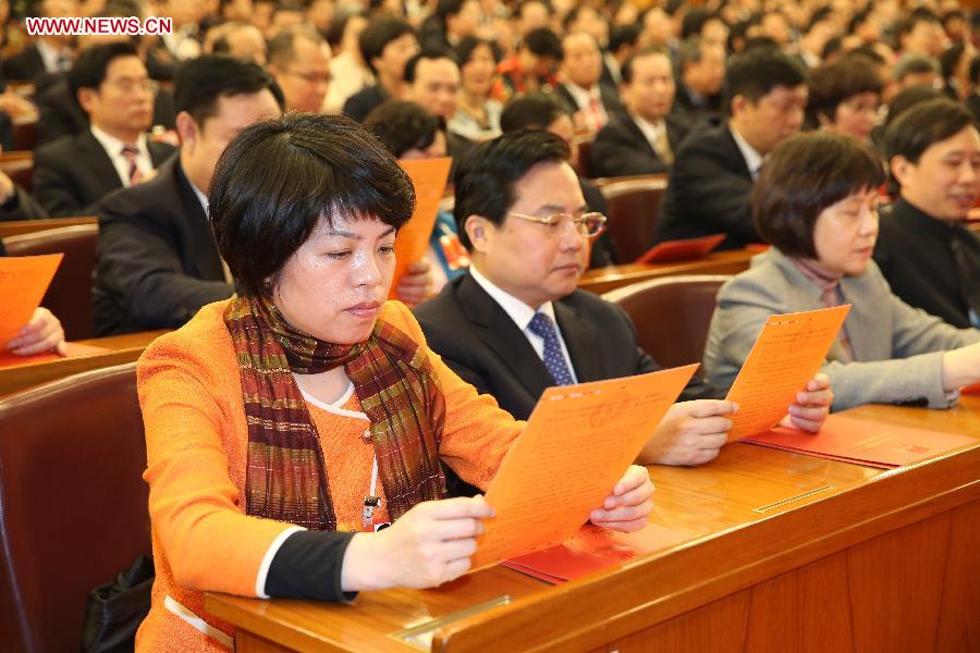 Deputies check voting sheets during the sixth plenary meeting of the first session of the 12th National People's Congress (NPC) at the Great Hall of the People in Beijing, capital of China, March 16, 2013. (Xinhua/Chen Jianli) 