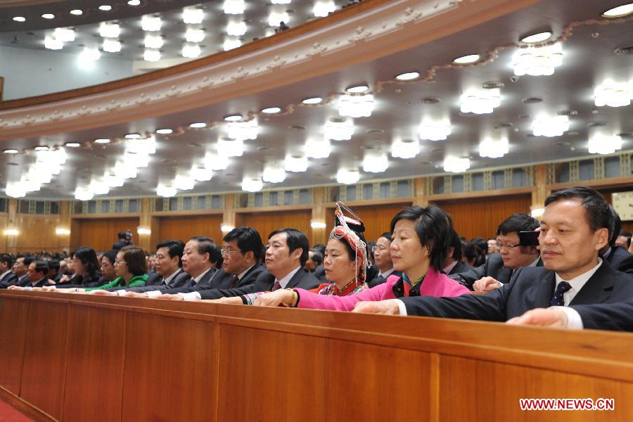 Deputies press buttons to vote during the sixth plenary meeting of the first session of the 12th National People's Congress (NPC) at the Great Hall of the People in Beijing, capital of China, March 16, 2013. (Xinhua/Xie Huanchi) 
