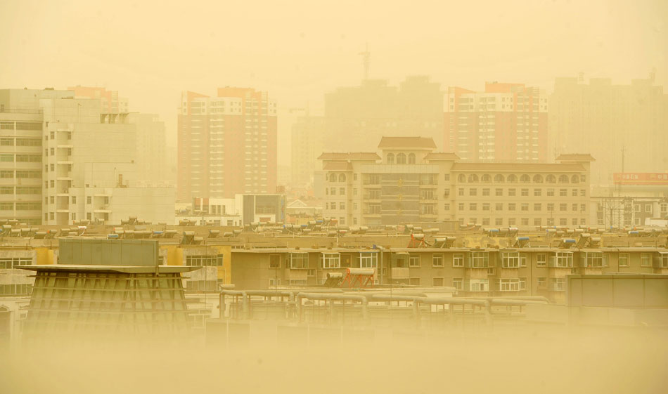 Buildings loom in sand and dust, Yinchuan, northwest China’s Ningxia Hui autonomous region, March 9, 2013. A cold front brought plenty of sand and dust to  many northern Chinese cities on last Saturday. (Xinhua/Peng Zhaozhi)