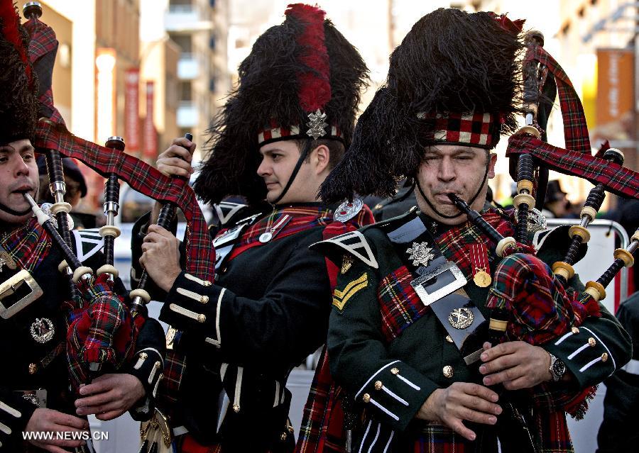 The Black Watch Pipes and Drums perform druing the annual St. Patrick's Day parade in Montreal, Quebec, Canada, March 17, 2013. Despite the bitter cold, an estimated 250,000 Montrealers lined the streets of the city to witness more than 100 organizations that took part in the event with floats and performances for the parade. (Xinhua/Andrew Soong)