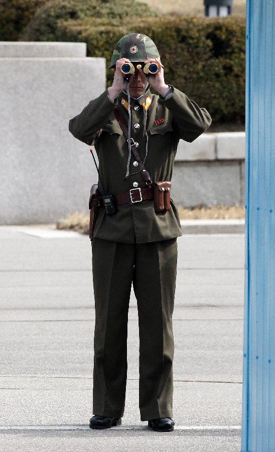 A soldier of the Democratic People's Republic of Korea (DPRK) stands guard at the truce village of Panmunjom in the demilitarized zone (DMZ) in Paju, South Korea, March 19, 2013. The annual joint military exercises of South Korea and the United States is scheduled to run from March 11 to March 21. (Xinhua/Park Jin-hee)