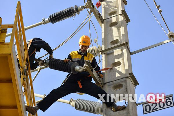 Chen Zhiqi and his colleagues were changing the insulators of overhead line system installed in the stretch of Qarhan Salt Lake of Qinghai Province, northwest China on March 14, 2013. [Photo/Xinhua] 