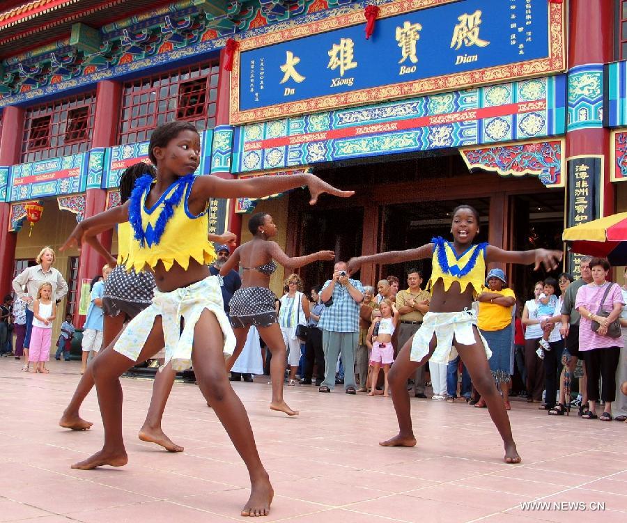 Local girls dance in front of the Nan Hua Temple, the largest Buddhist temple and seminary in Africa, in Bronkhorstpruit near Johannesburg, South Africa, Jan. 29, 2006. Cultural and people-to-people exchanges have been reinforced between China and African countries over past decades, thus deepening mutual understanding and traditional friendship between the two peoples. Chinese President Xi Jinping will visit Tanzania, South Africa and the Republic of Congo later this month and attend the fifth BRICS summit on March 26-27 in Durban, South Africa. (Xinhua/Chen Ming) 