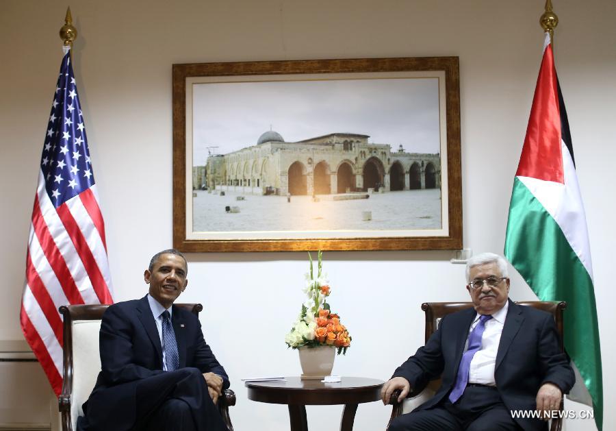 Palestinian President Mahmoud Abbas (R) shakes hands with his U.S. counterpart Barack Obama during their meeting in the West Bank city of Ramallah on March 21, 2013. Obama arrived in Tel Aviv in Israel Wednesday to start his Mideast tour. Obama will spend three days in Israel, the Palestinian territories and Jordan. (Xinhua/POOL/Fadi Arouri)