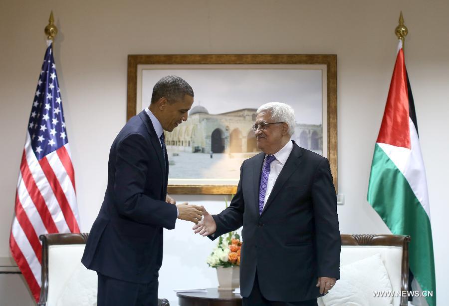 Palestinian President Mahmoud Abbas (R) shakes hands with his U.S. counterpart Barack Obama during their meeting in the West Bank city of Ramallah on March 21, 2013. Obama arrived in Tel Aviv in Israel Wednesday to start his Mideast tour. Obama will spend three days in Israel, the Palestinian territories and Jordan. (Xinhua/POOL/Fadi Arouri)