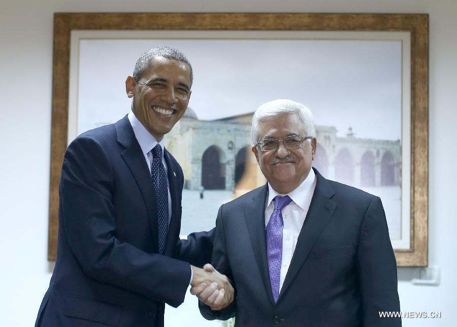 Palestinian President Mahmoud Abbas (R) poses with his U.S. counterpart Barack Obama for photo during their meeting in the West Bank city of Ramallah on March 21, 2013. Obama arrived in Tel Aviv in Israel Wednesday to start his Mideast tour. Obama will spend three days in Israel, the Palestinian territories and Jordan. (Xinhua/POOL/Fadi Arouri)